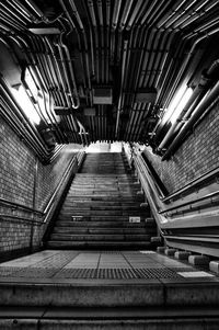 Low angle view of staircase in illuminated tunnel