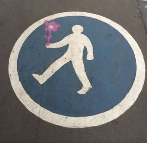 Close-up of bicycle sign on road