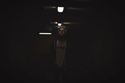 Man standing in illuminated room