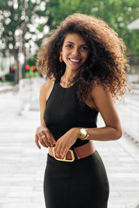 Portrait of a smiling young woman standing outdoors