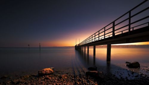 View of bridge over river against sky during sunset