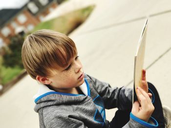 Close-up of boy holding book