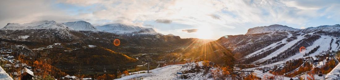 Panoramic view of snowcapped mountains against sky