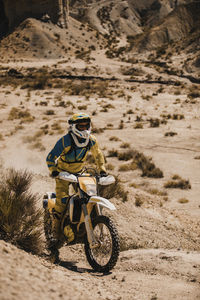 Man riding bicycle on desert