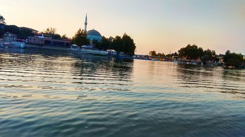 Scenic view of river against sky during sunset