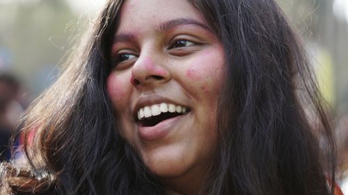 Close-up portrait of smiling young woman