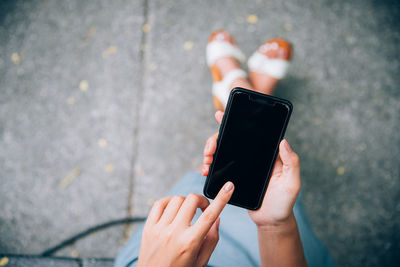 Midsection of person holding mobile phone