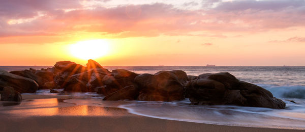 Scenic view of sea against sky at sunset