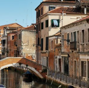 Canal amidst buildings in city