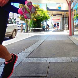 Low section of people walking on road