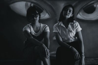 Young woman sitting in corridor