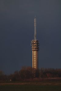 Clock tower against sky in city at night