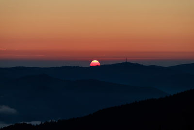 Scenic view of silhouette mountain against romantic sky at sunset