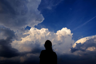 Silhouette woman standing against sky