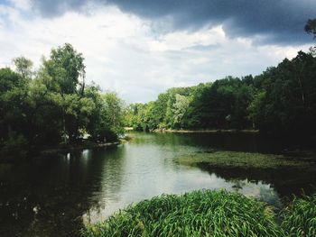 Scenic view of lake against cloudy sky