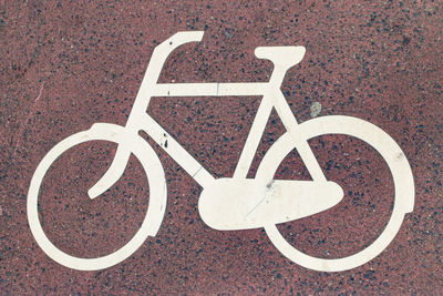 Directly above shot of bicycle lane symbol on road