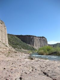 Scenic view of cliff against clear sky