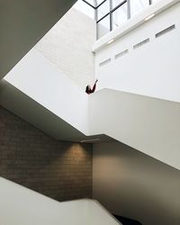 Low angle view of man on staircase against building