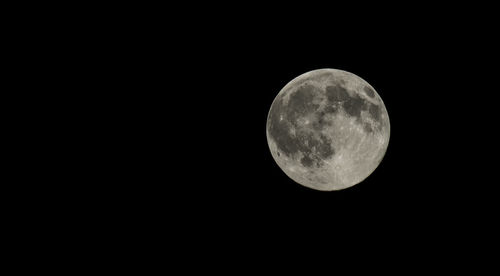 Low angle view of moon against dark sky