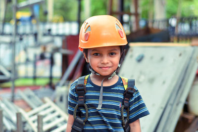 Portrait of little boy wearing helmet and harness