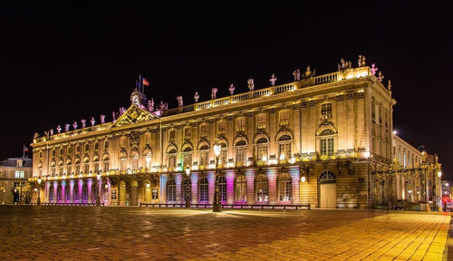 Illuminated building against sky at night