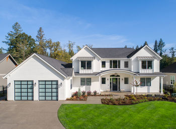 Beautiful modern farmhouse style luxury home exterior with blue sky