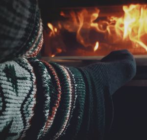 Low section of person against fireplace