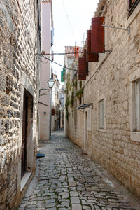 Alley amidst buildings against sky