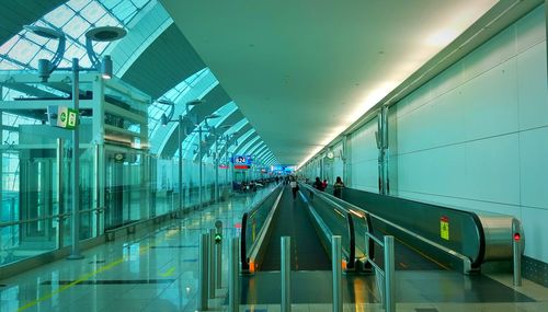 People using escalator at airport