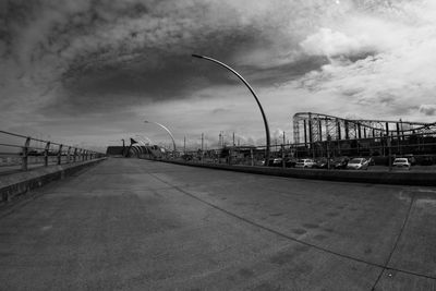 Bridge over road in city against sky