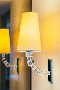 Close-up of illuminated electric lamps attached on wall