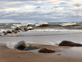 Rocks on beach against sky