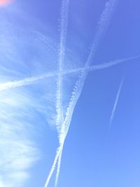 Low angle view of vapor trail against clear blue sky