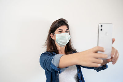 Portrait of young woman using smart phone