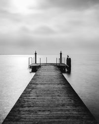 Pier over sea against sky