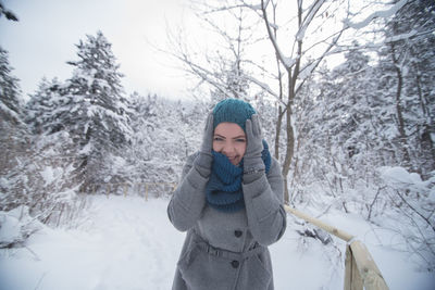 Woman standing on snow covered land