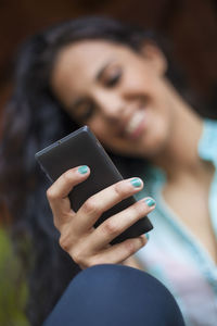 Midsection of woman using mobile phone