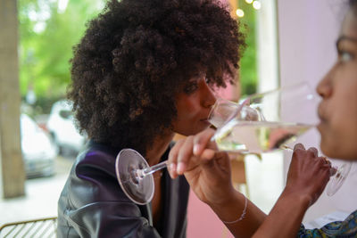 Side view of woman drinking wine