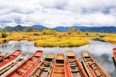 Scenic view of river by mountains against sky