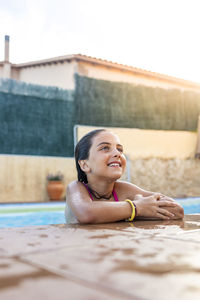 Funny kid smiling on a pool side