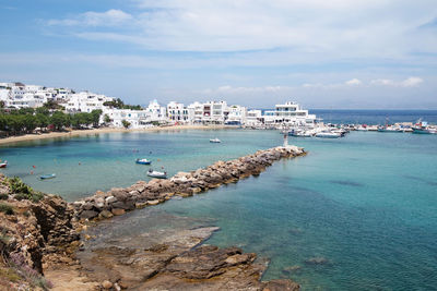 Scenic view of sea and buildings against sky