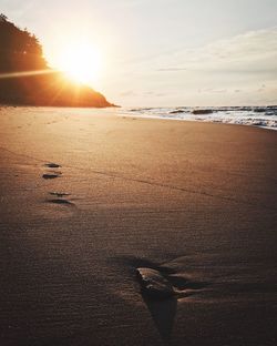 Scenic view of beach against sky during sunset