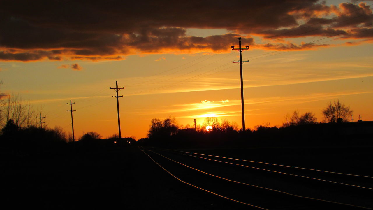 sunset, orange color, electricity pylon, sky, power line, silhouette, cloud - sky, scenics, tranquil scene, landscape, sun, tranquility, electricity, tree, beauty in nature, nature, road, power supply, field, the way forward