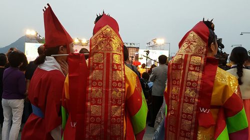 People at temple against sky in city