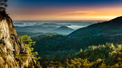 Scenic view of mountains against sky at sunset