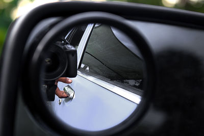 Close-up of hand on side-view mirror