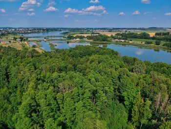 High angle view of trees by lake against sky