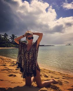 Rear view of woman standing on beach