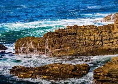 Waves splashing on rocks at shore