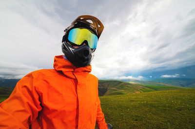 Portrait of a racer in full protection of a full face mask on a bicycle or motorcycle in the summer